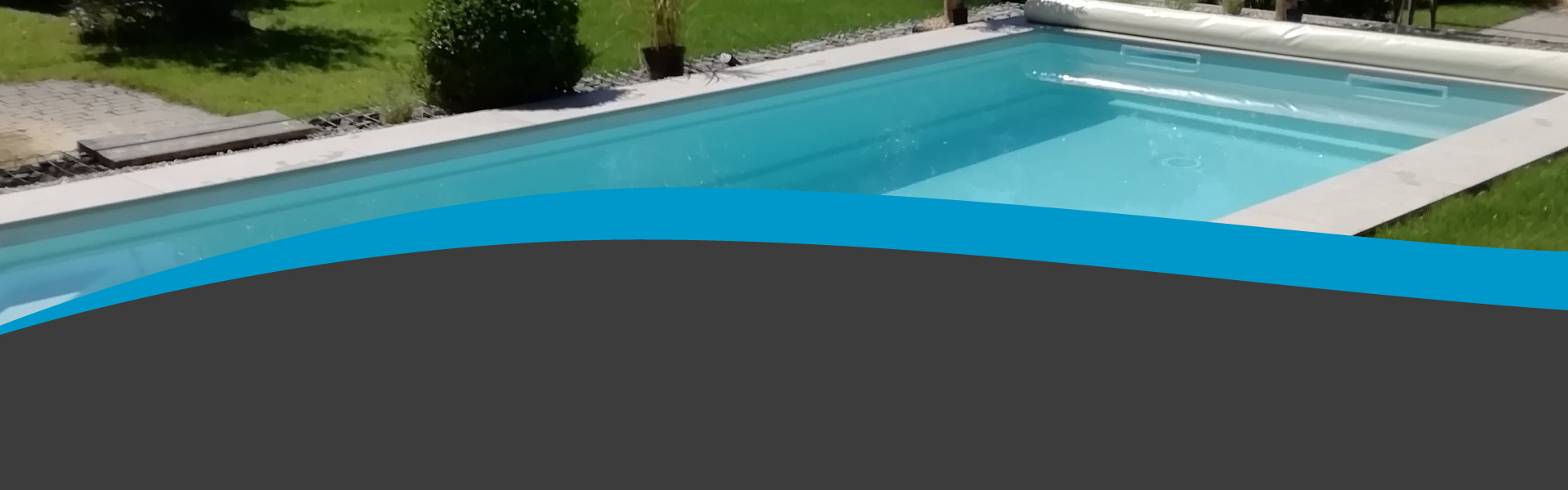 Hellblauer Pool im mit reflektierenden Sonnenstrahlen. Im Hintergrund ist eine Wiese mit Sträuchern.